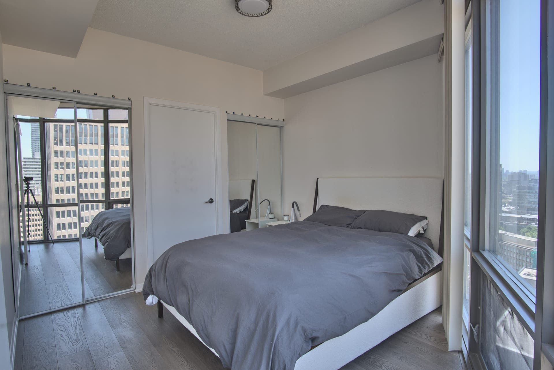 Downtown Skyline Condo — Bedroom overlooking the city